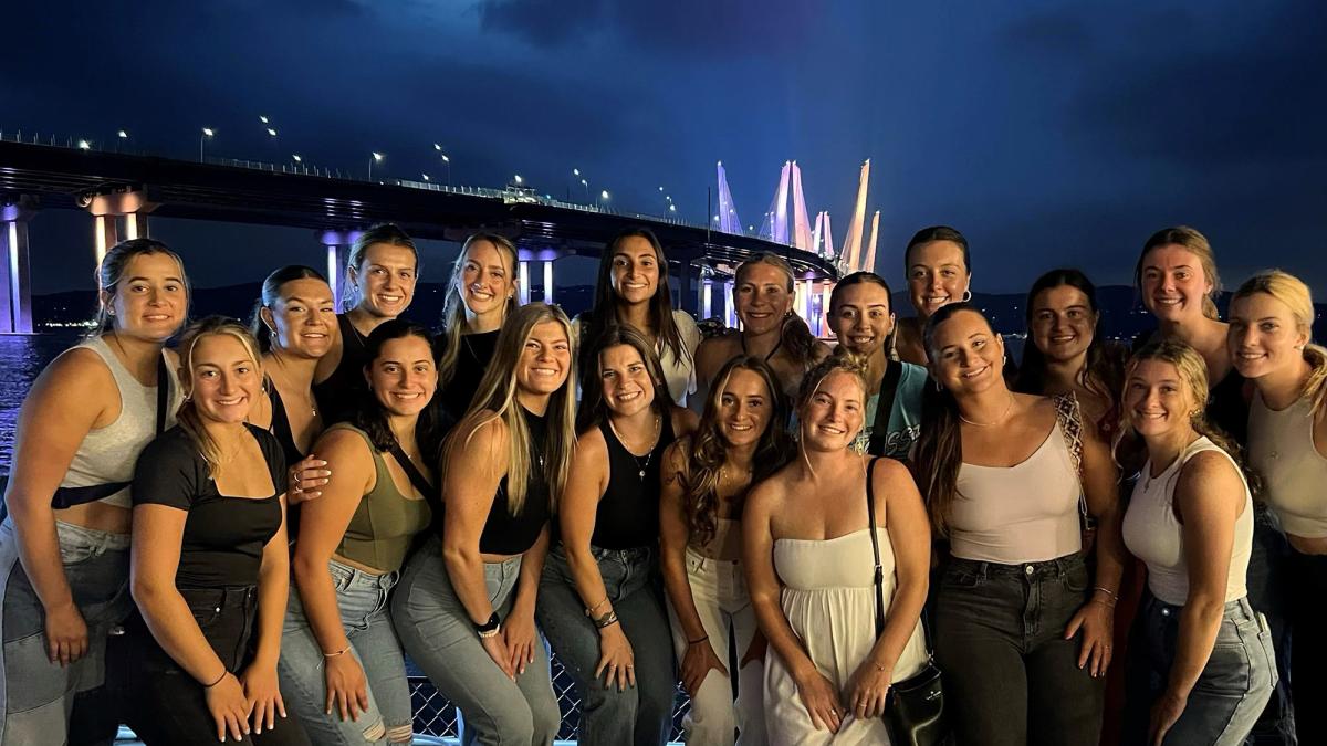 Pace National Champion Women's Lacrosse team posing below the Mario Cuomo Bridge