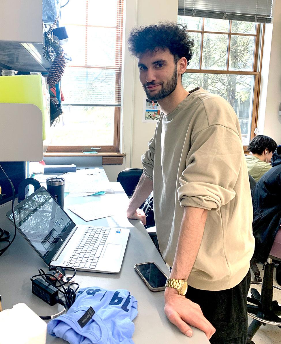 Pace University's Biology student Michael Ferretti doing research on a laptop