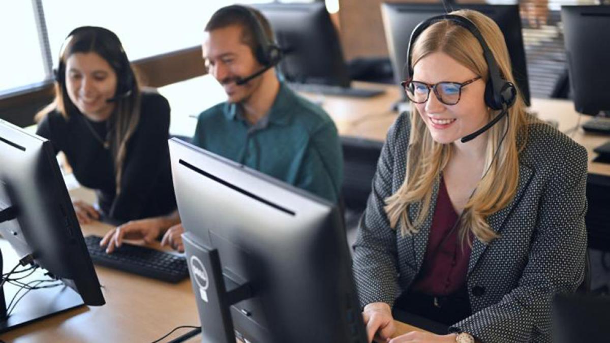 stock image of people in call center behind computers