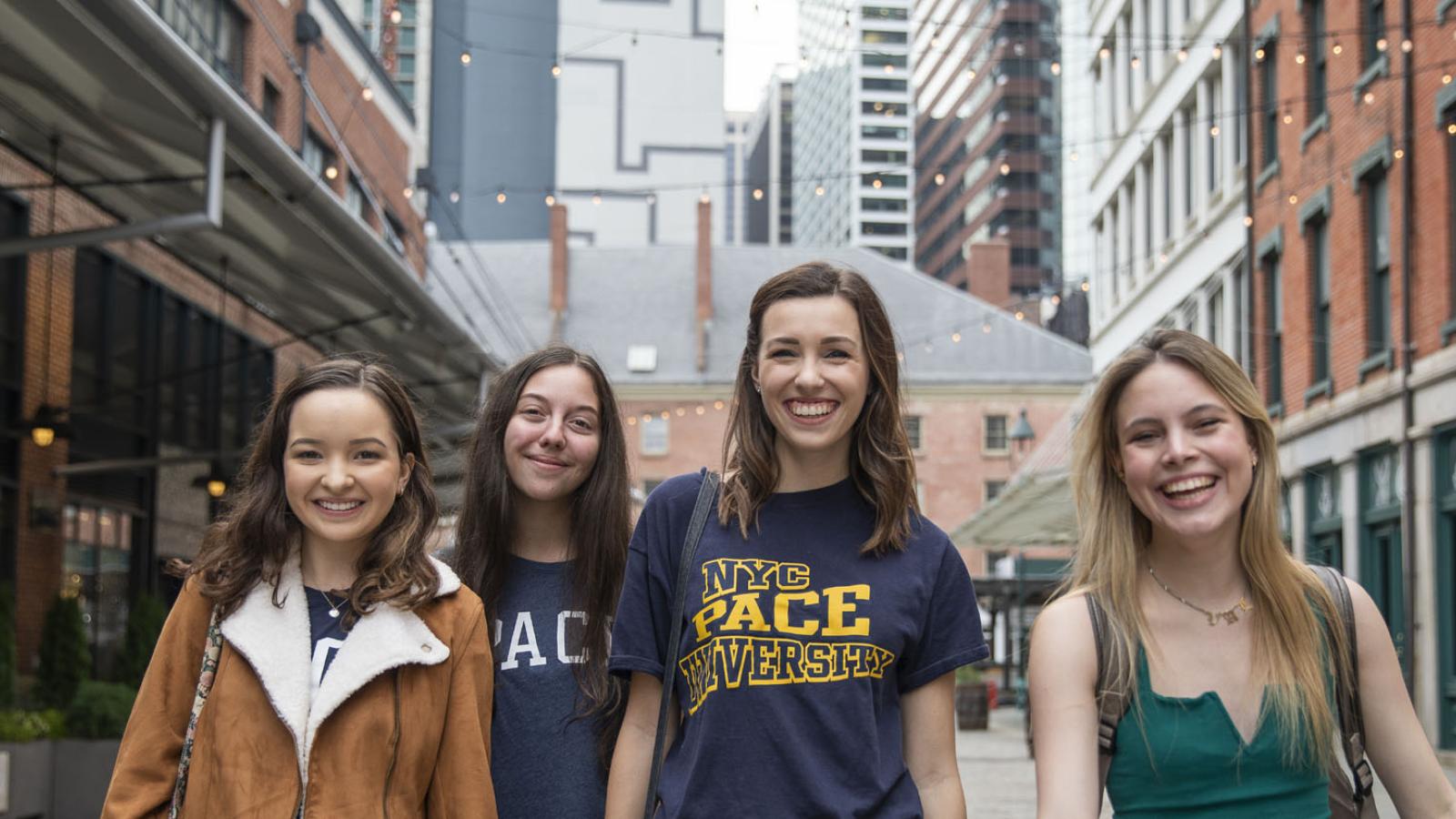 three Pace students walking in the South Street Seaport in Lower Manhattan near the New York City Campus