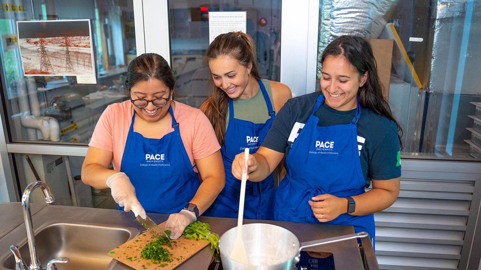 Students cooking at the Nutrition and Dietetics Teaching Kitchen at Pace University.