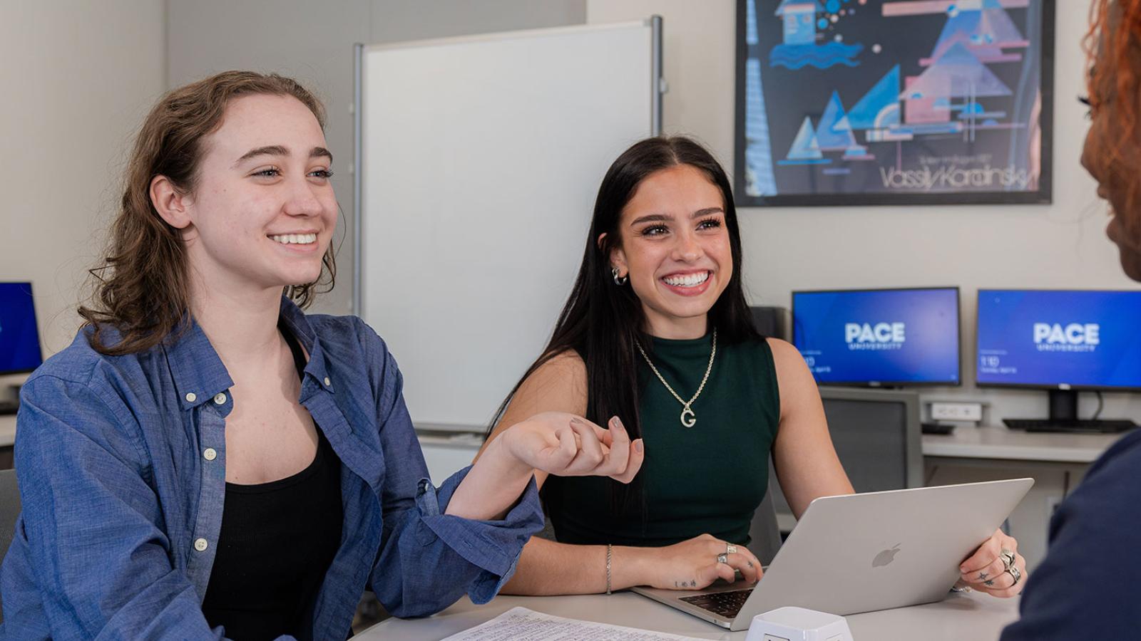Group of Pace University students sitting at a table, studying together.
