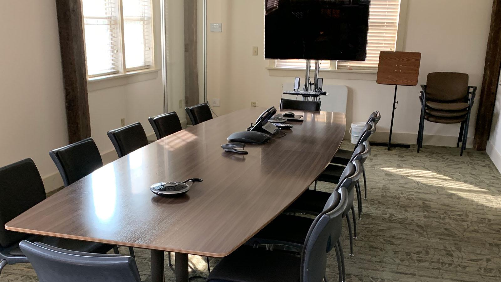 Long conference room table with TV at the head