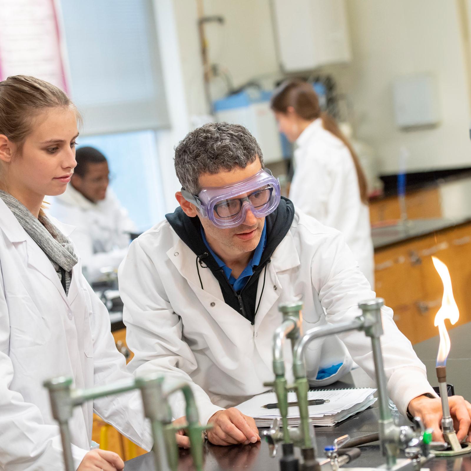 Pace University's Pleasantville Chemistry lab student working with professor using a bunsen burner