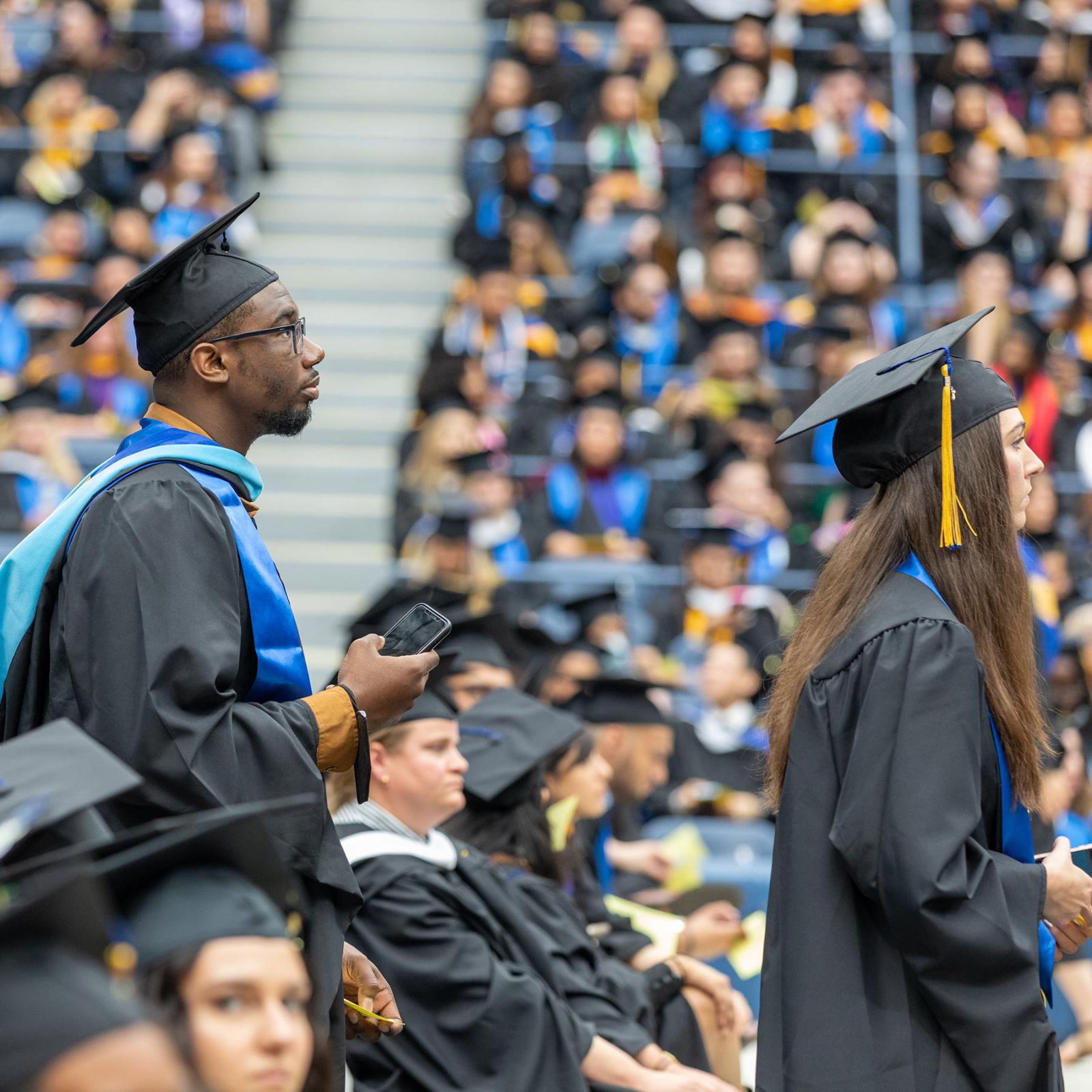Pace University students standing in a crowd at their commencement ceremony