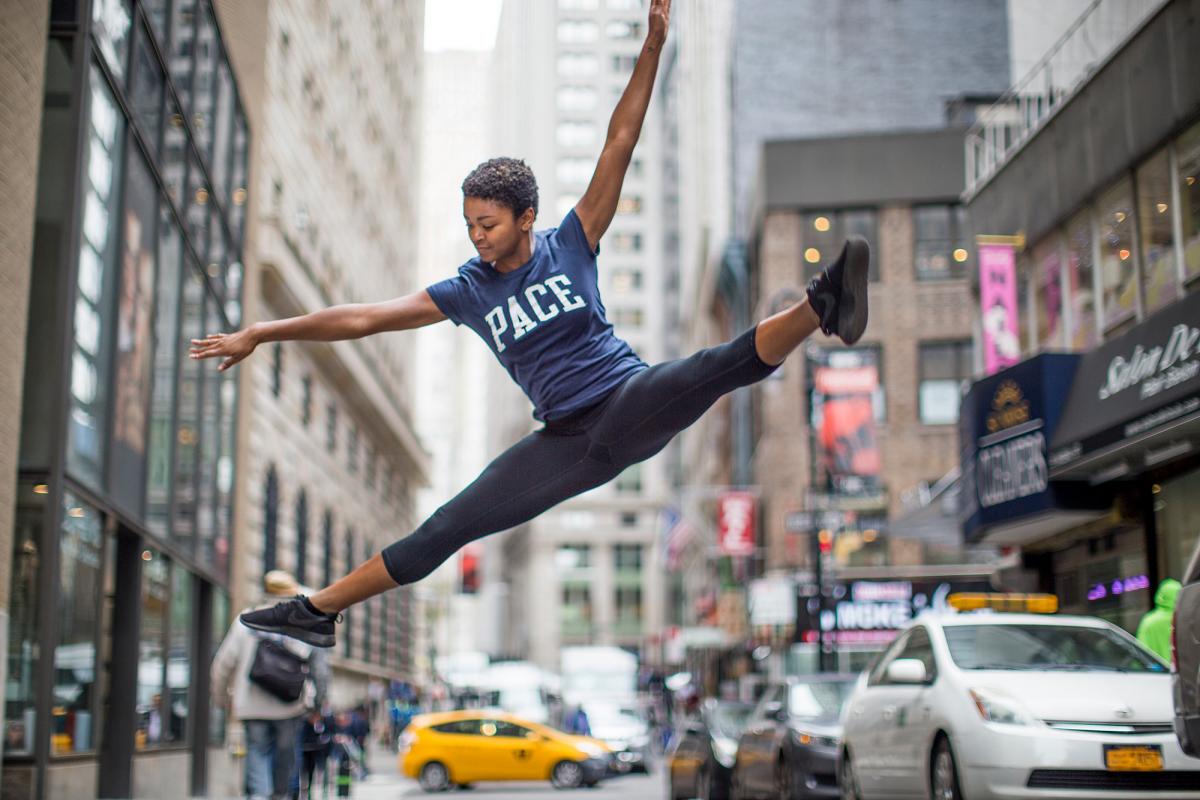 Student jumping in the air in NYC.
