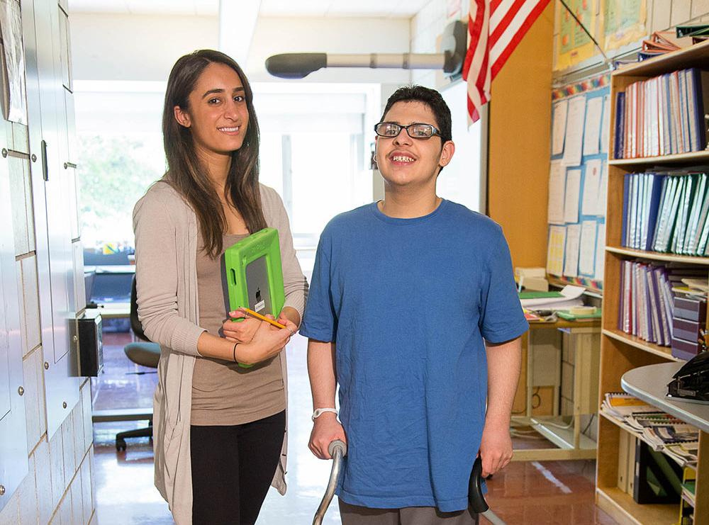 School of Education student working with a child in a classroom.