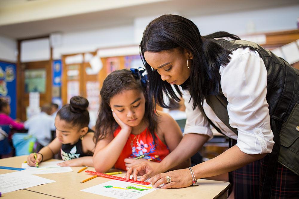 School of Education student working with children in a classroom.