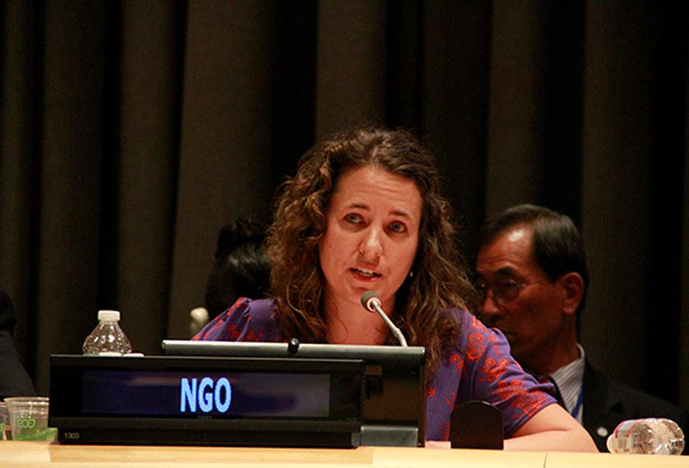 Emily Welty at the United Nations behind an NGO sign