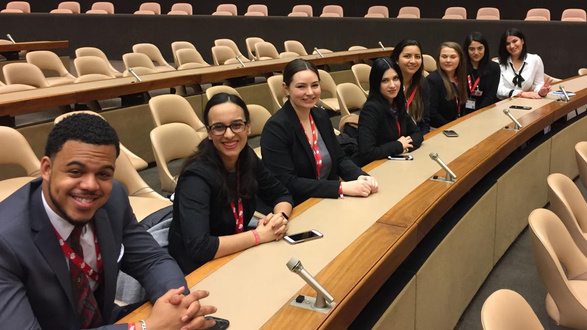 Students sitting behind the microphones of the United Nations