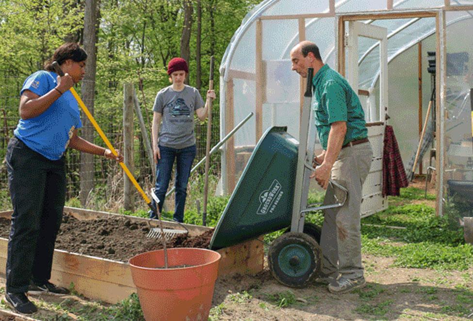 Students and professor Angelo Spillo tending to the vegetable gardens