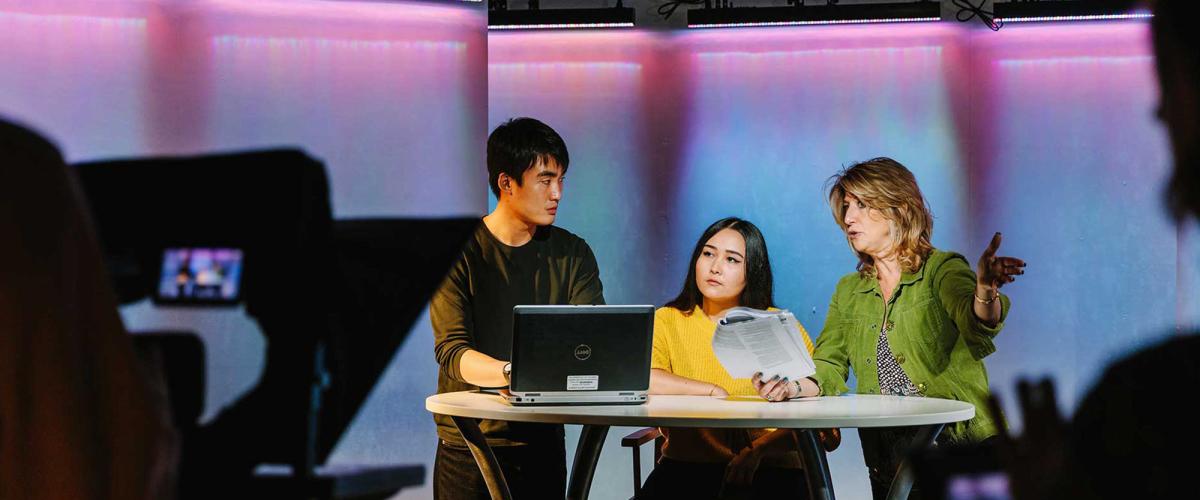 Students and professor working in a tv studio.