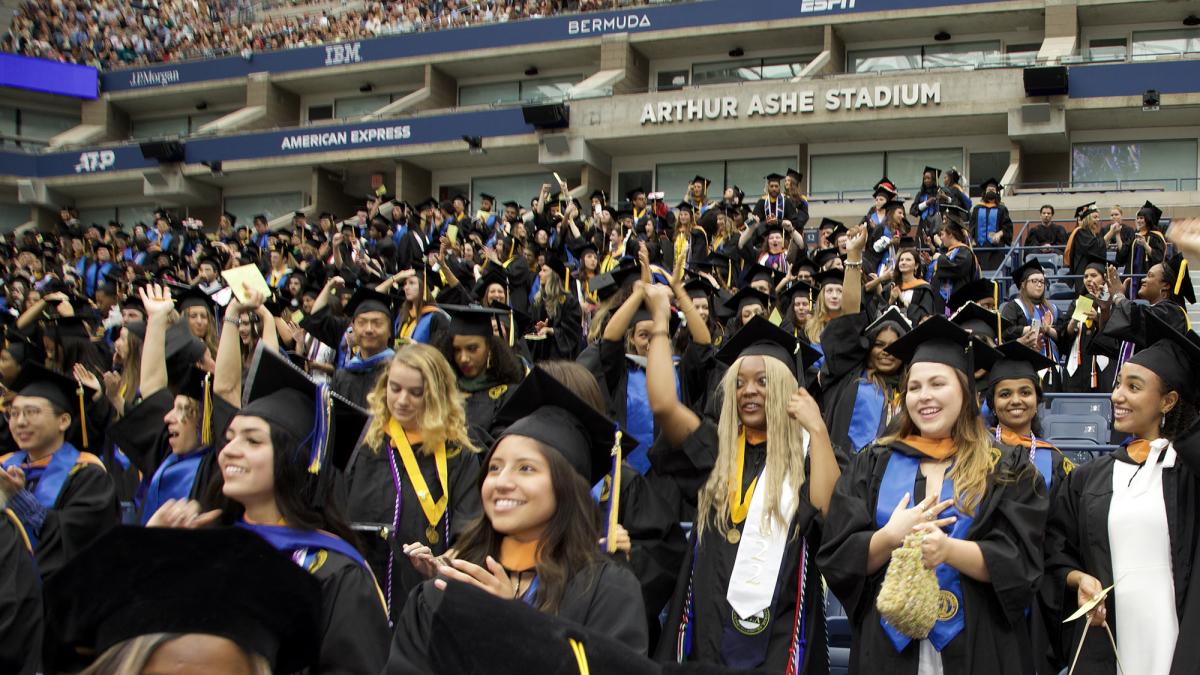 Students celebrating at Pace University’s Commencement at the USTA Billie Jean King National Tennis Center in Queens.