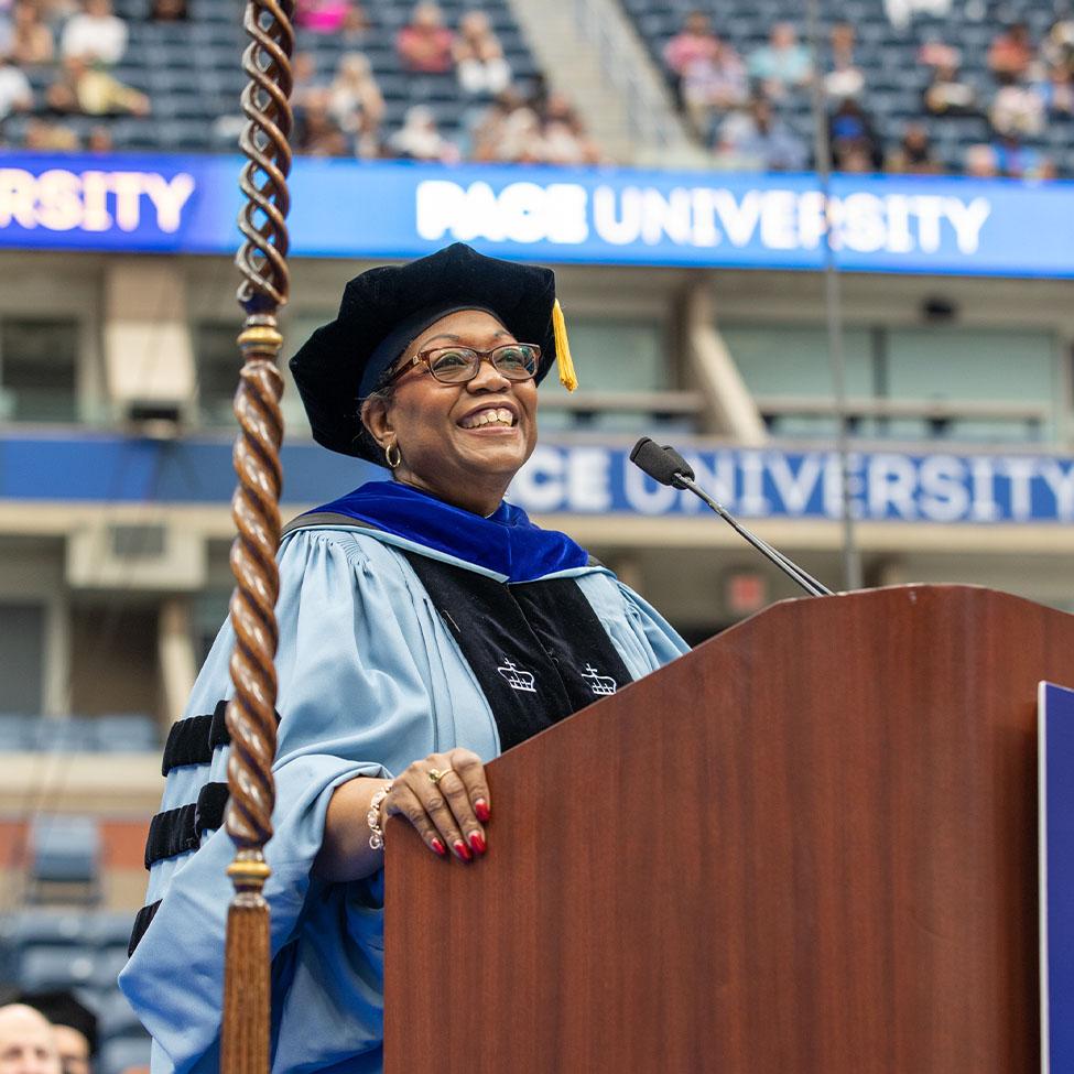 Tresmaine at podium speaking infront of 2022 Commencement