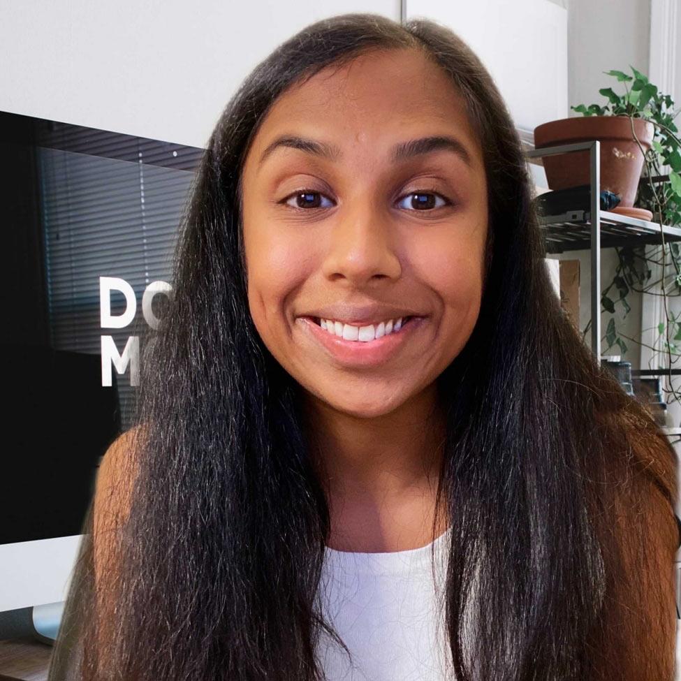 smiling woman with long hair and white top