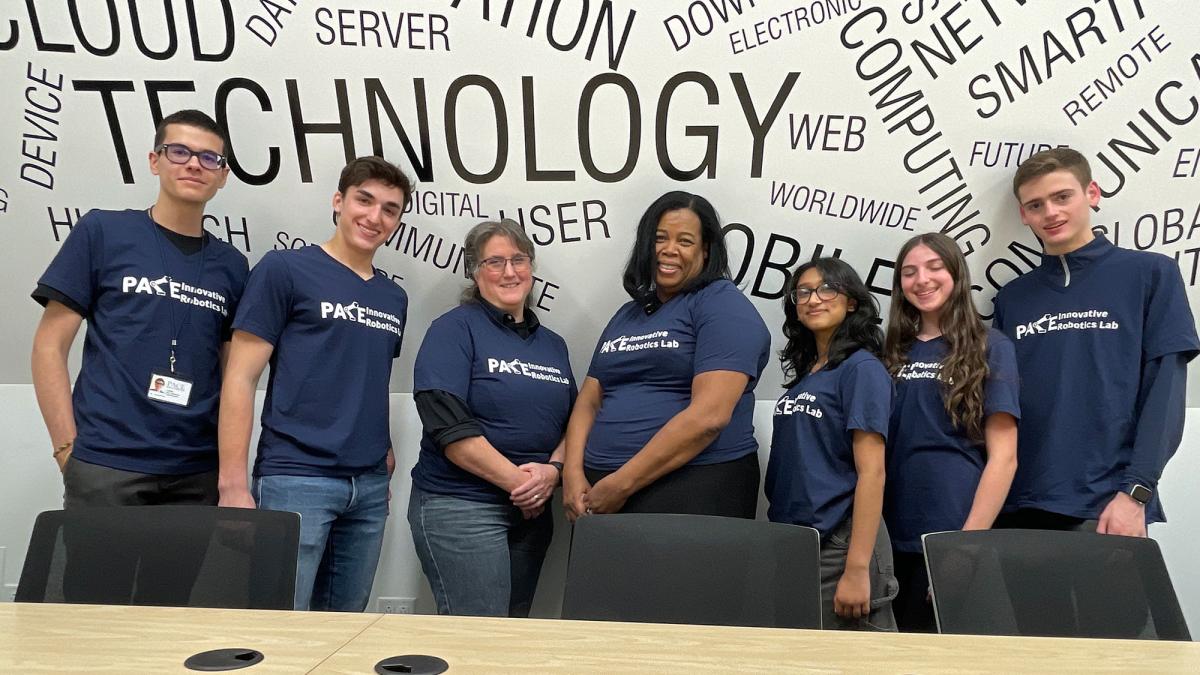 Pauline Mosley and Lisa Ellrodt with high school students who have worked on the T-Bot Robot