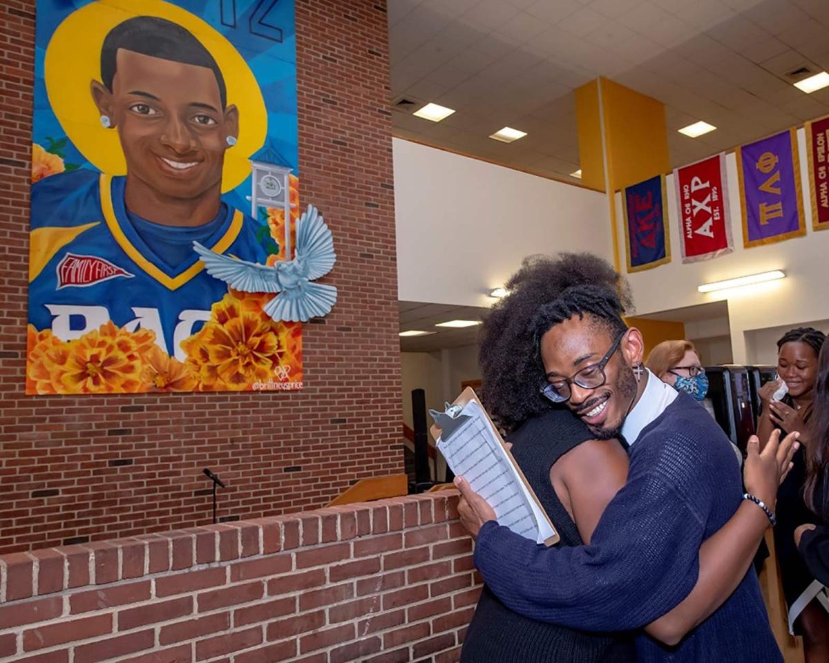 Pace student Ja’Rette Mungin hugs artist Brittney Price during a mural unveiling ceremony during last year’s Social Justice Week ceremonies honoring Danroy “DJ” Henry Jr.