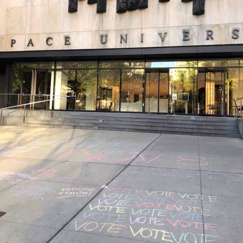 The entrance of One Pace Plaza with the chalk writing on the ground that reads, Vote