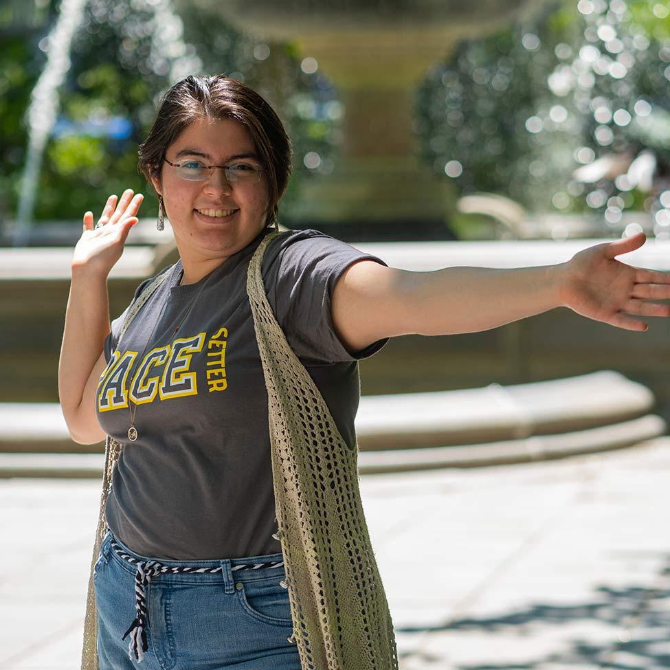 person smiling with arms outstretched