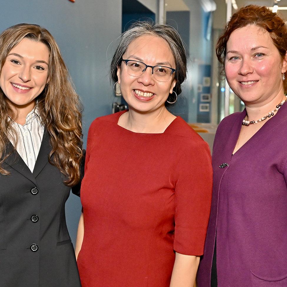 three women smiling for camera