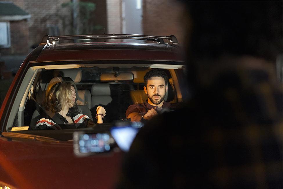 video camera pointed at young people in a car