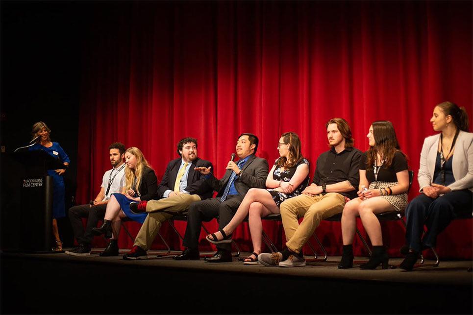 student sitting on stage