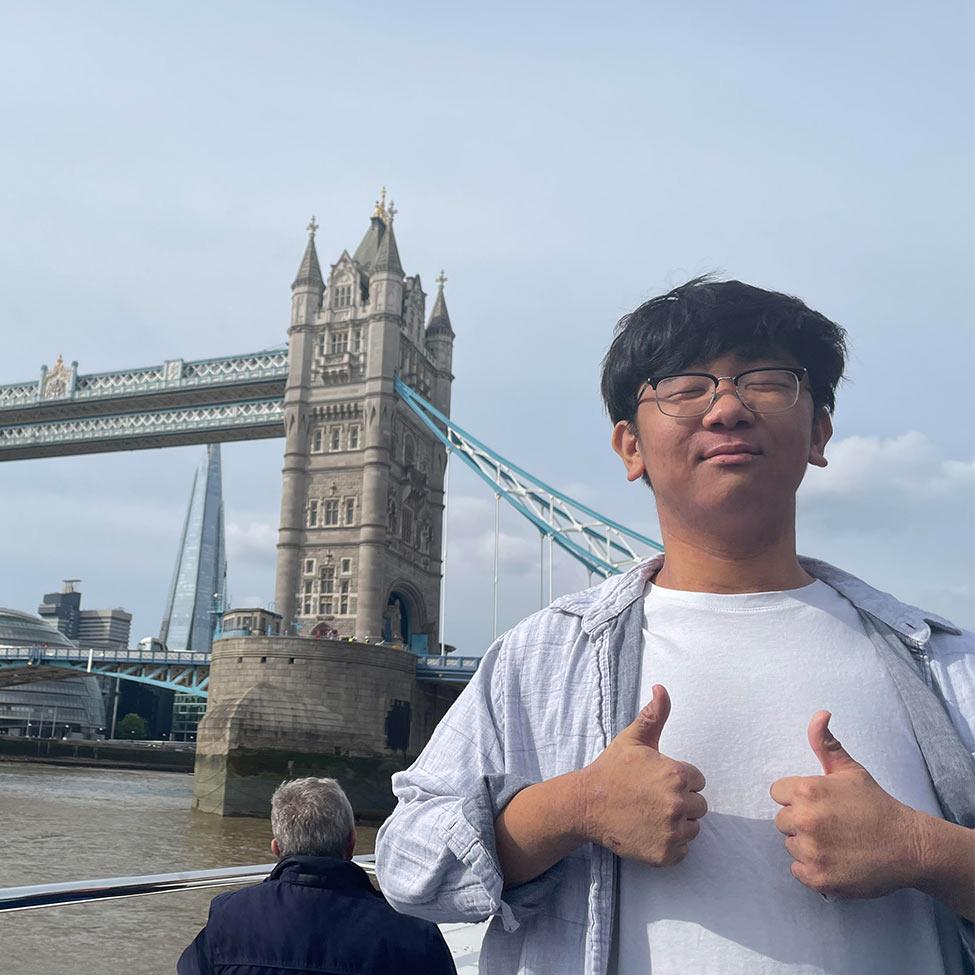Pace University student posing in front of tower bridge in London