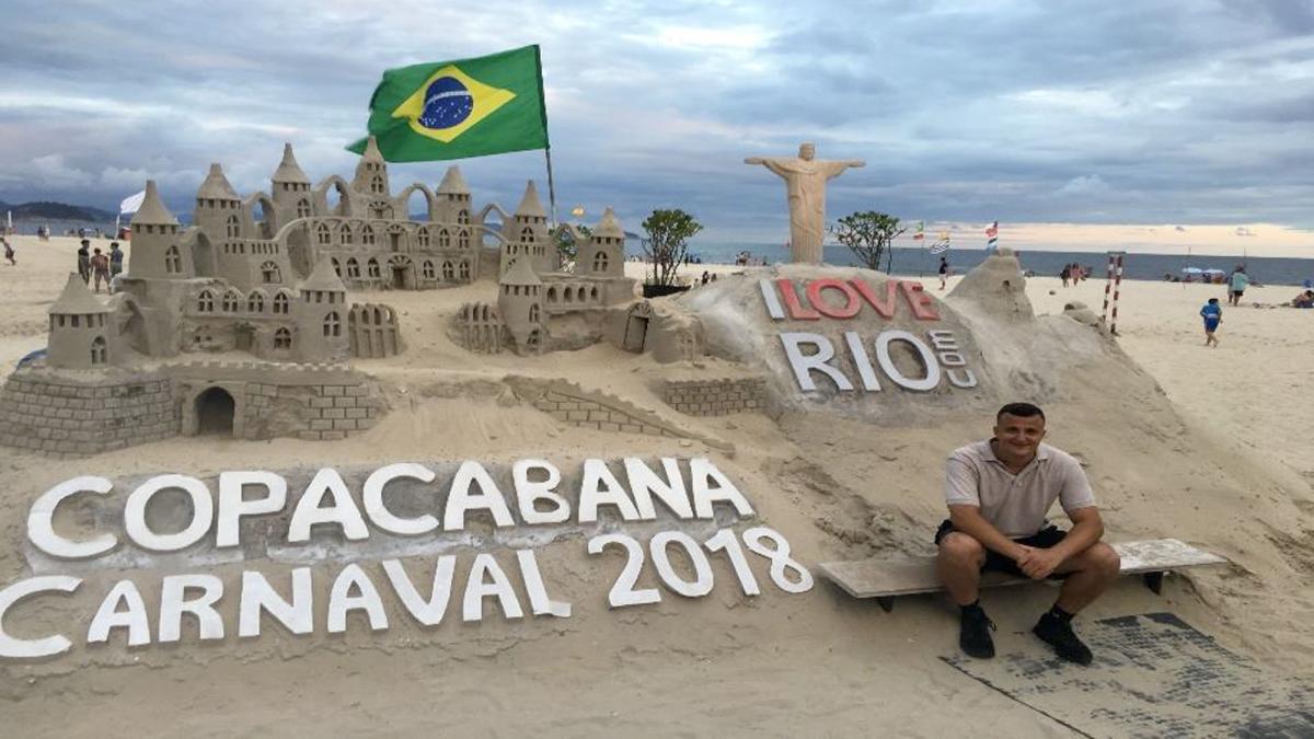 Lubin student Brian Maxwell '19 sitting on the beach at the Copacapana Carnival in 2019 during his semester abroad in Brazil
