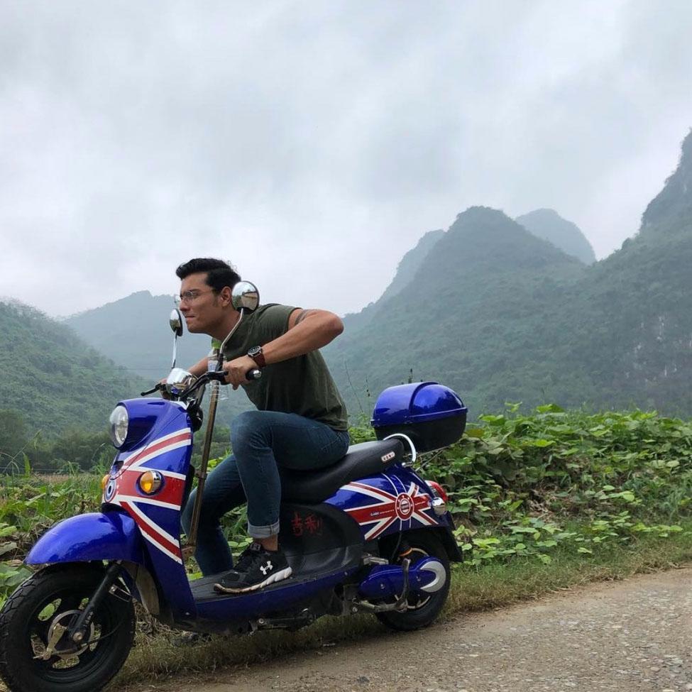 Lubin student Brandon Morales '21 riding a motorcycle emblazoned with the Union Jack British flag through country roads with mountains in the background during his semester abroad in Hong Kong 