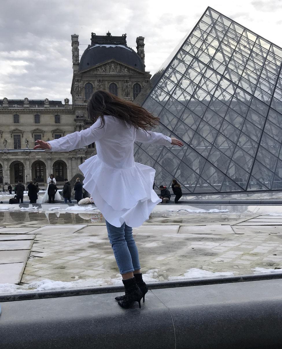 Lubin student Olena Hauser'20 in front of the Louvre Museum's glass pyramid in Paris during her semester abroad in Italy