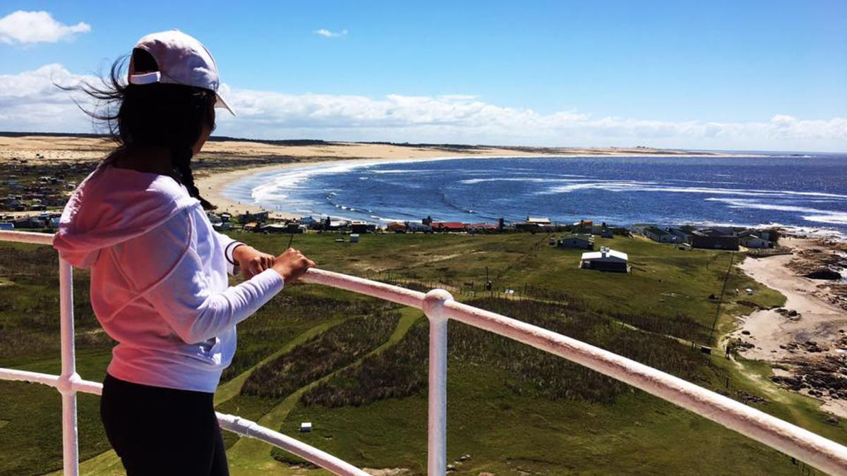 Lubin student Cristina Nolasco '18 standing at a lookout point on a hill over the sea during her semester abroad in Uruguay