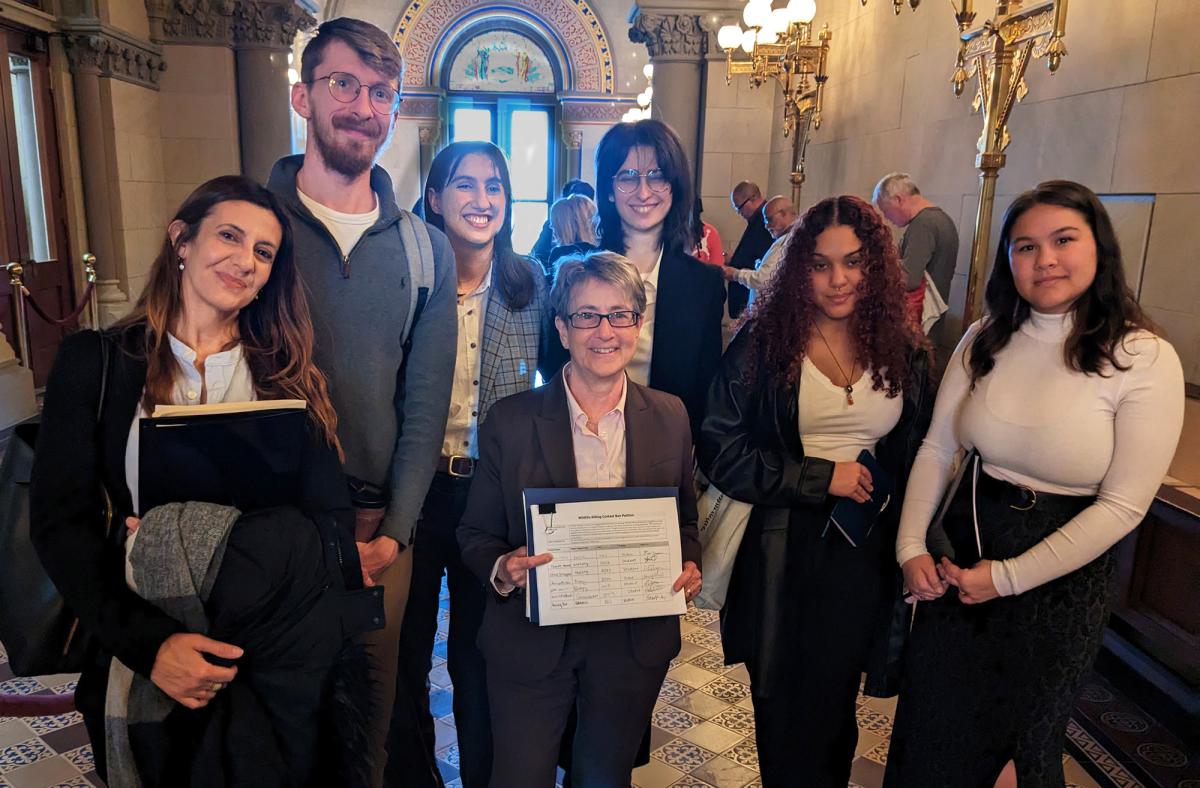 Animal Policy Project students standing together with a petition