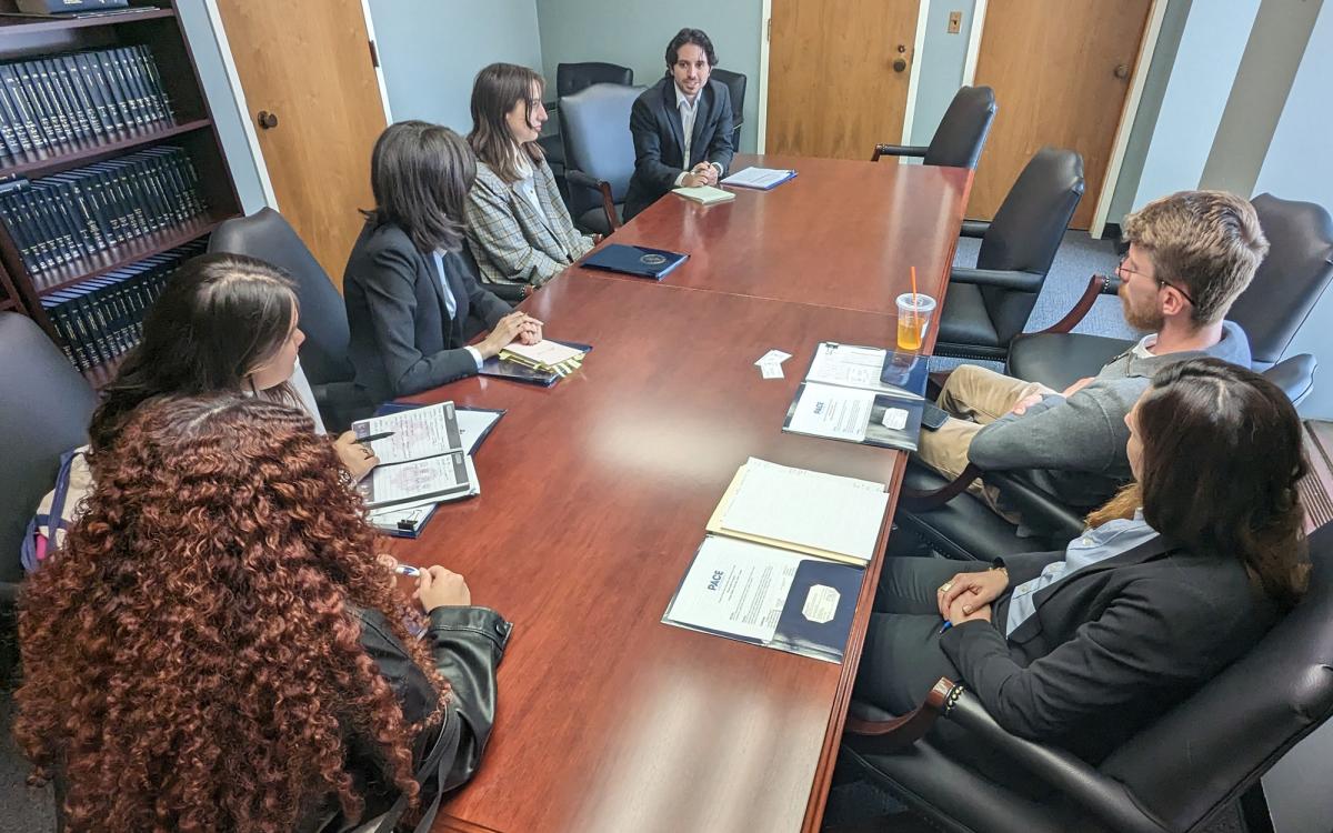 Group of Animal Policy Project students sitting around a table during a business meeting
