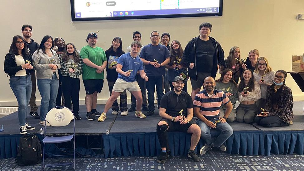 George Chacko, Rich Miller, and the students of their first ever audiovisual class stand on stage after completing the AV Olympics