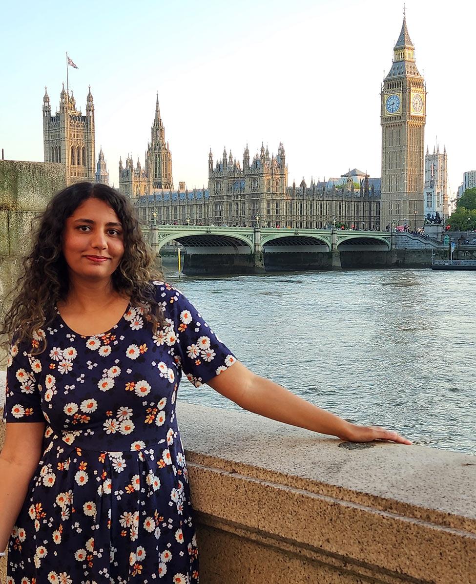 Female Publishing program alum from Pace University, Sabeen Aziz, standing near water