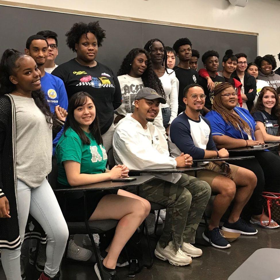 high school students smiling in a classroom