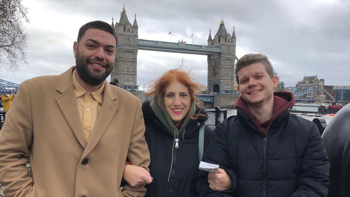 three Pace University Lubin students standing in front of the Tower Bridge in London during a 2019 international field study