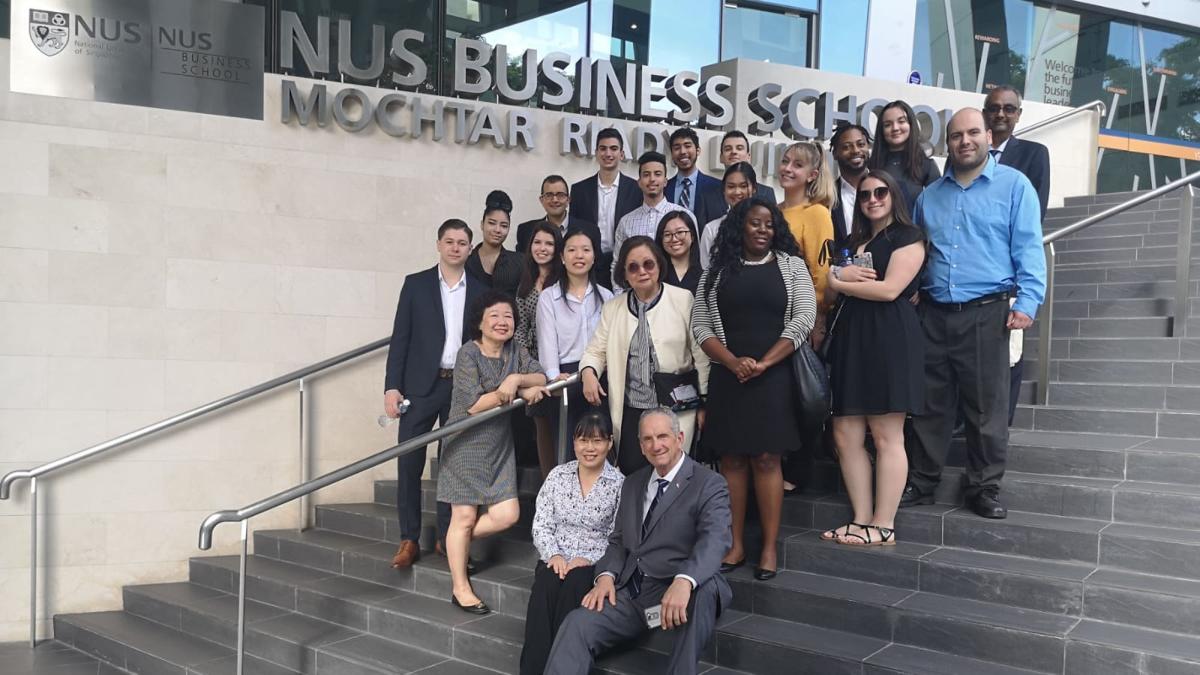 group of Pace University Lubin students and professors on the steps of National University of Singapore 2019 field study to Singapore and Malaysia