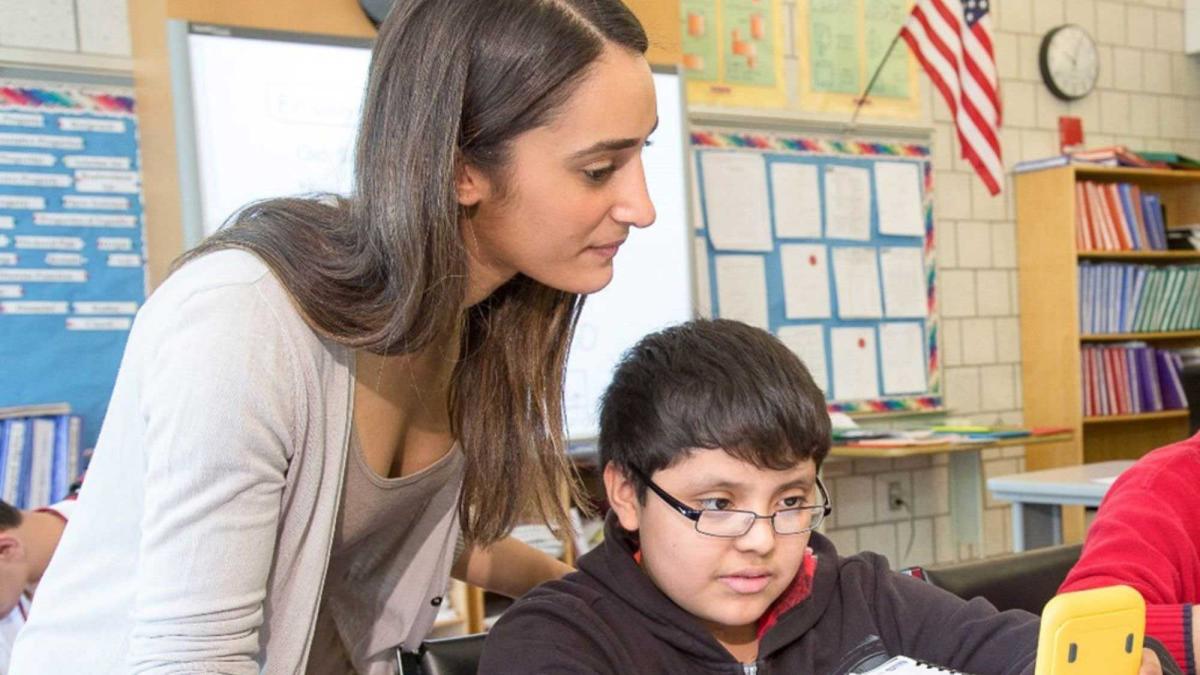 Teacher instructing a young student