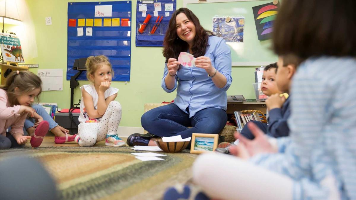 Teacher instructing children in an early childhood classroom setting