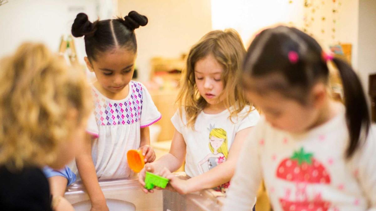 Small children learning and playing in a classroom