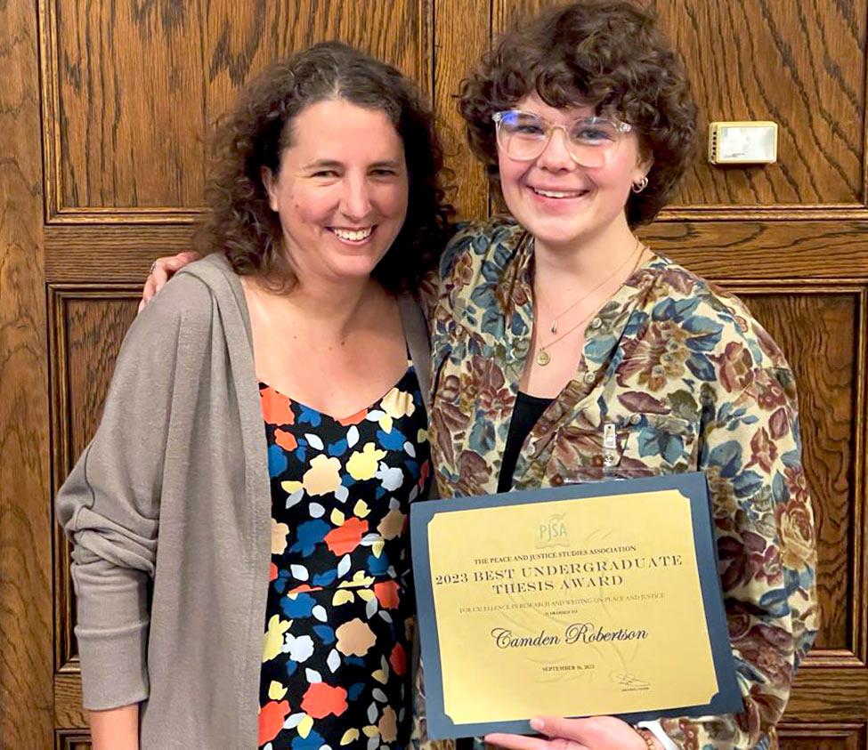 Pace University's Peace and Justice Studies student Camden Robertson with her award
