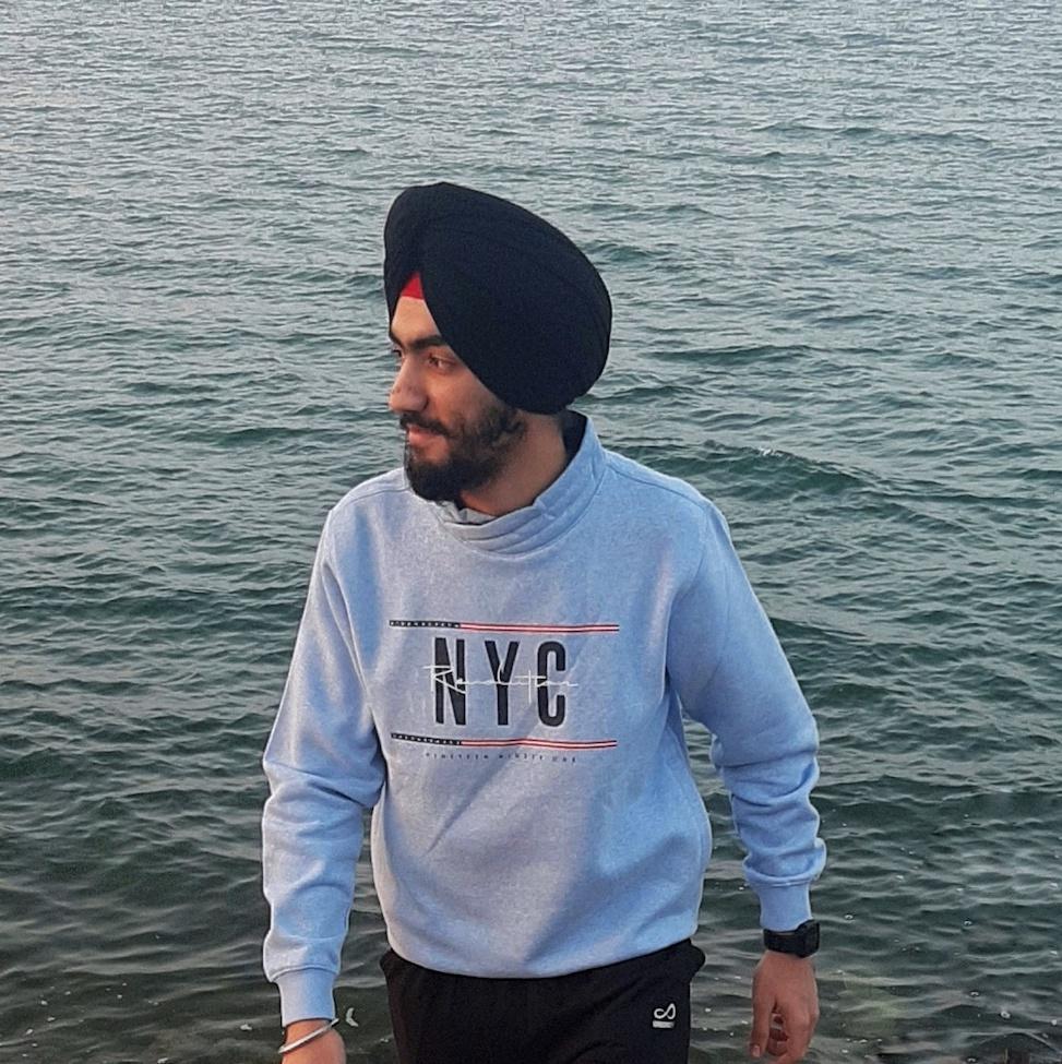 Pace University student Arshdeep Singh standing next to a body of water