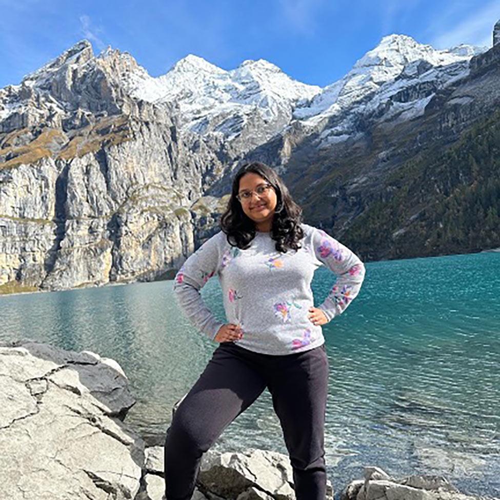 Lydia Lutchman, an undergraduate Management, Entrepreneurship major at Pace University, standing in front of a mountain range.