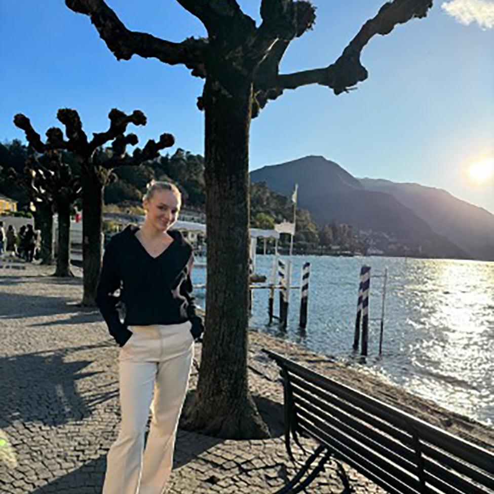Natalie Ziajski, an undergraduate Advertising and Integrated Marketing Communications major at Pace University, standing along a coastal walkway in Italy