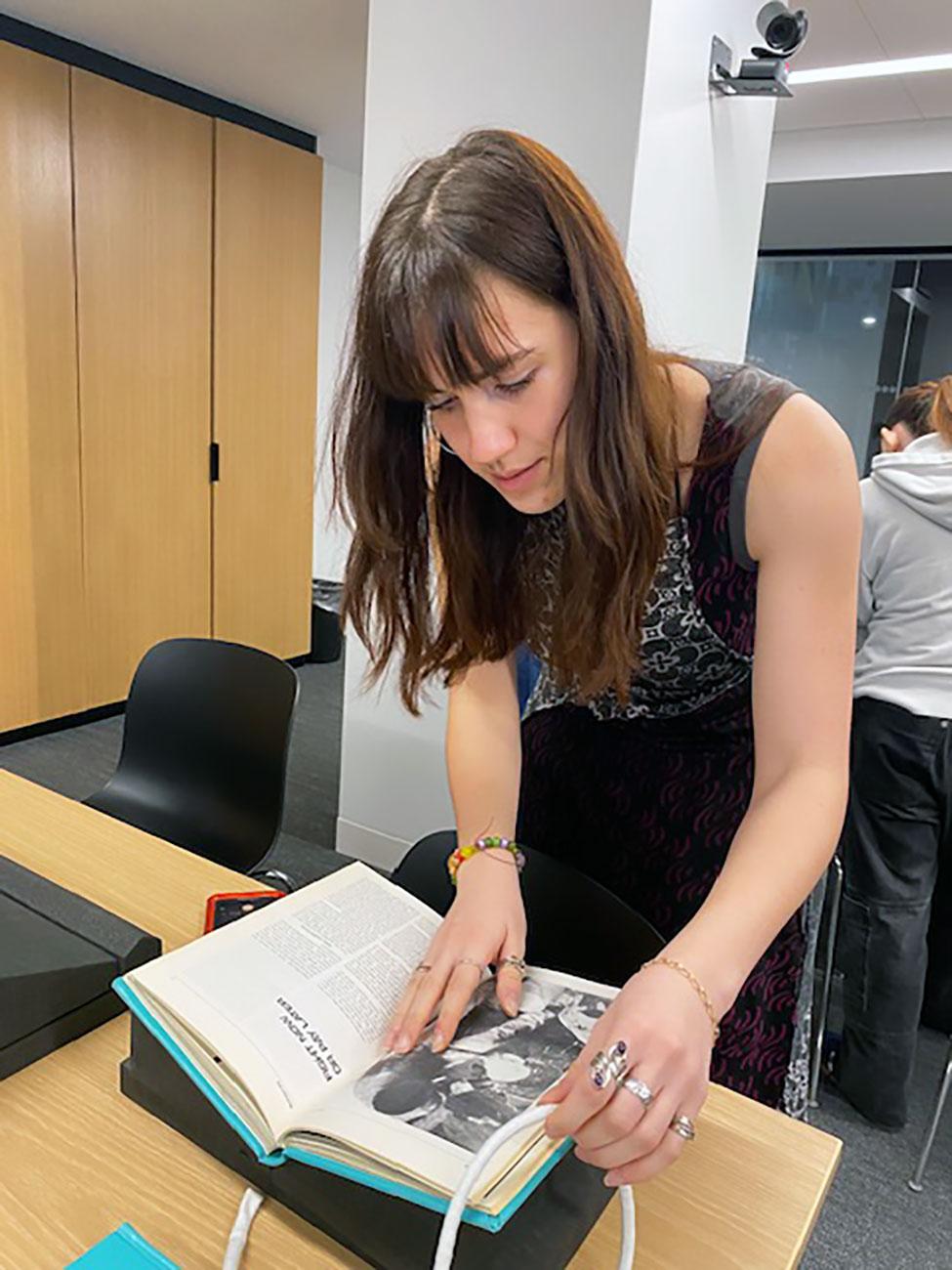 Pace University History student looks at a Latin American history book in the NACLA’s archives.