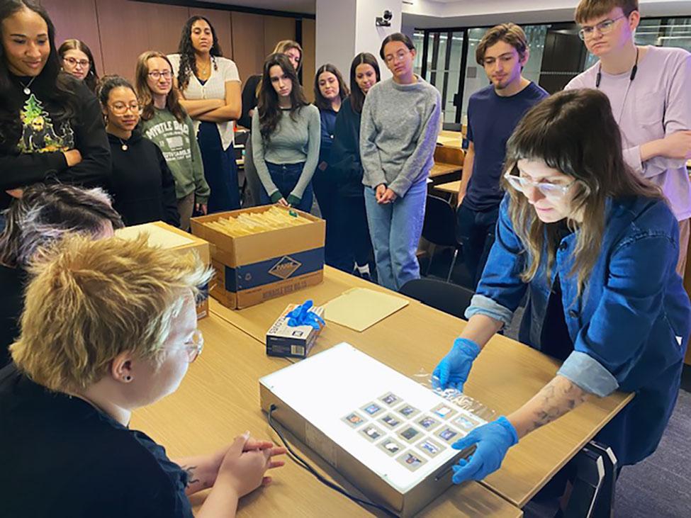 Pace University's Associate Professor of History Michelle Chase, PhD, and her students look at significant events in Latin America together through NACLA’s film slide archives on a lightboard.