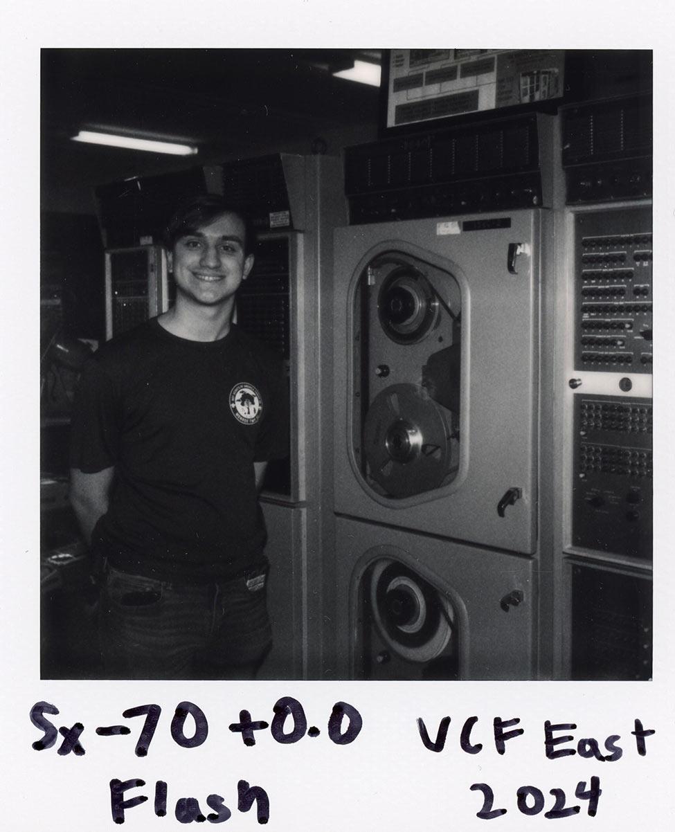 A black and white polaroid of Pace student Steven Schiavone with the UNIVAC 1219 naval computer