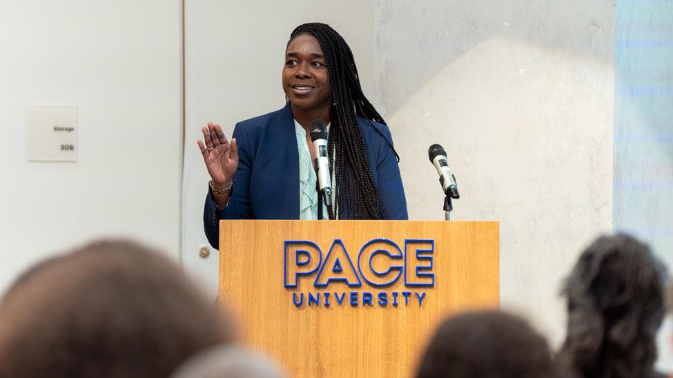 Stephanie Akunvabey speaking at a podium.