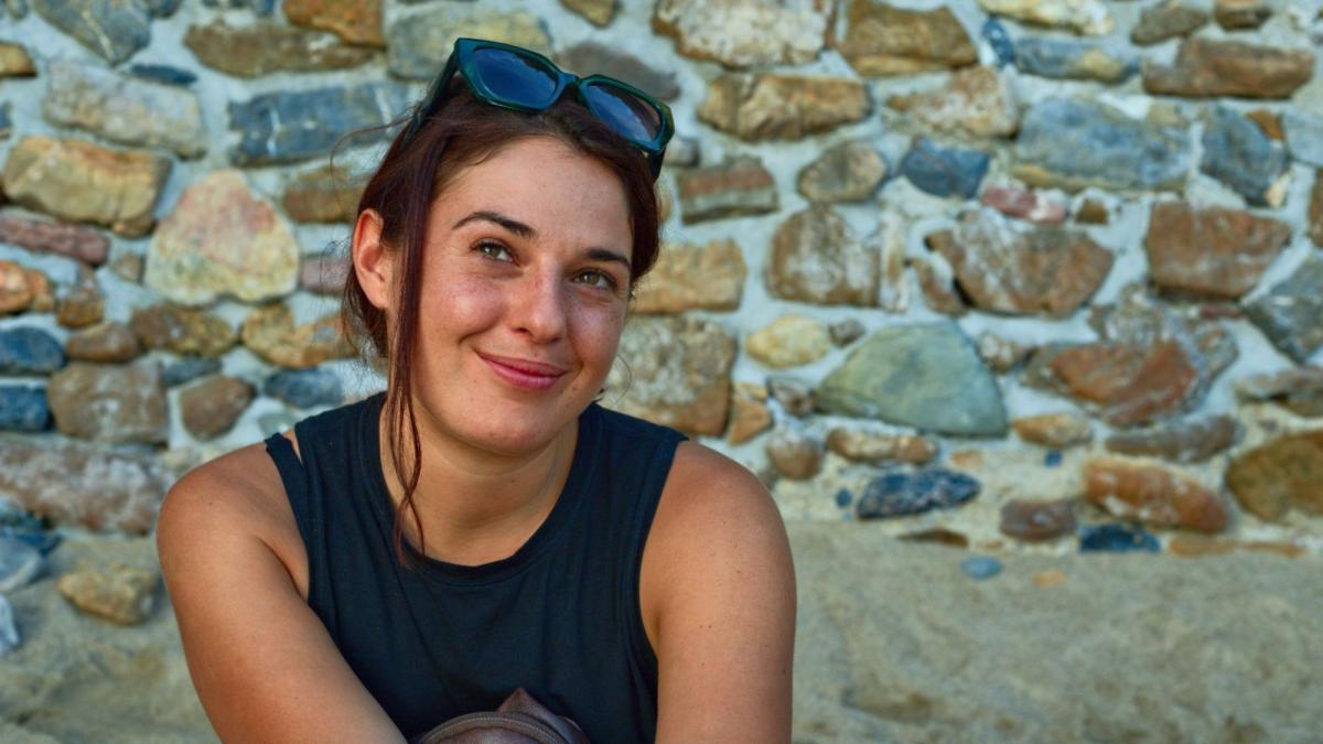 Seidenberg professor Sara Falcone, posing for a photo in front of a rocky wall.